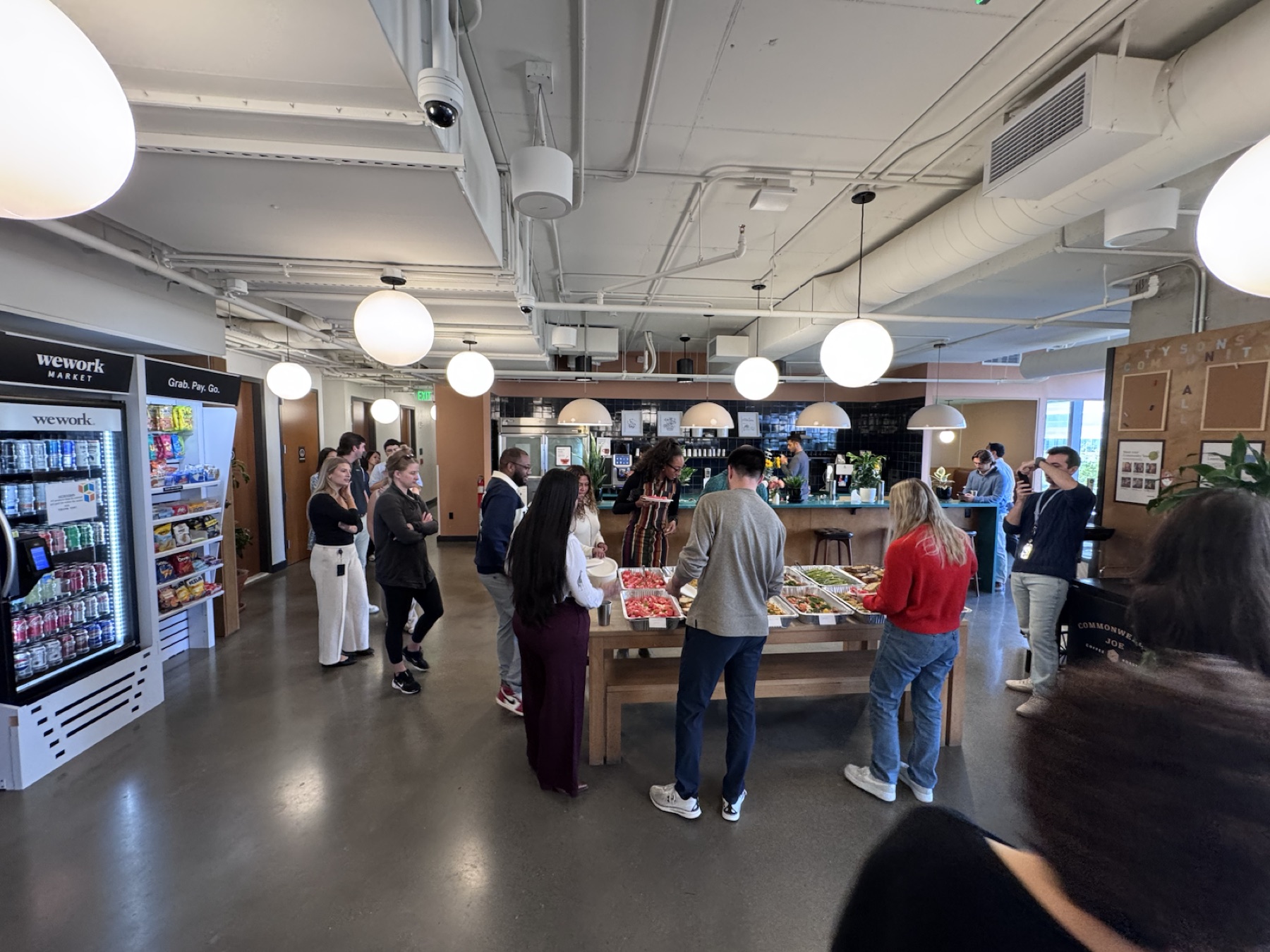 Office guests gathering around a Falcon & Fig drop-off catering buffet