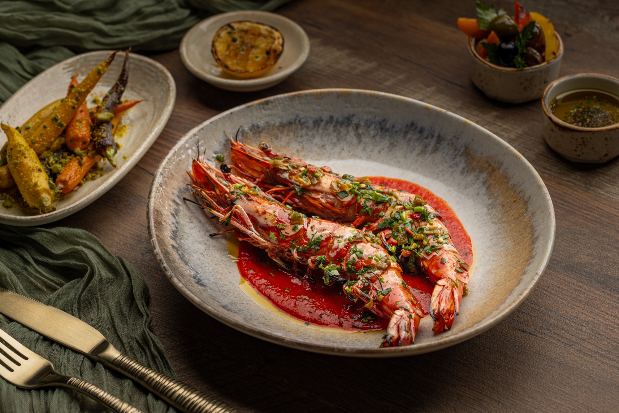 Grilled prawns in piquillo sauce with chimichurri and glazed carrots